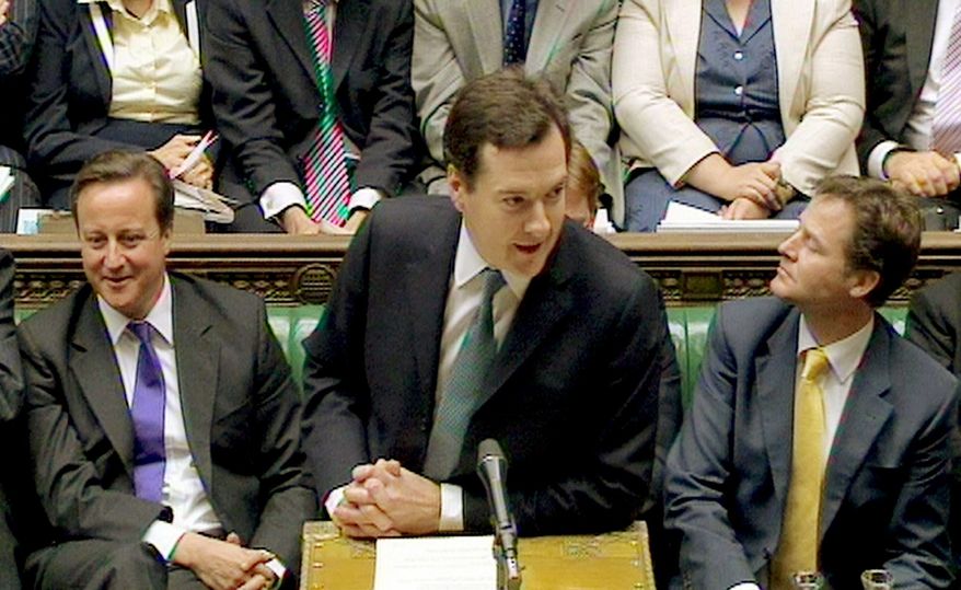 George Osborne, Britain's Treasury chief (center), delivers the Comprehensive Spending Review in London on Wednesday. Mr. Osborne ordered $128 billion in spending cuts through 2015. (Associated Press)