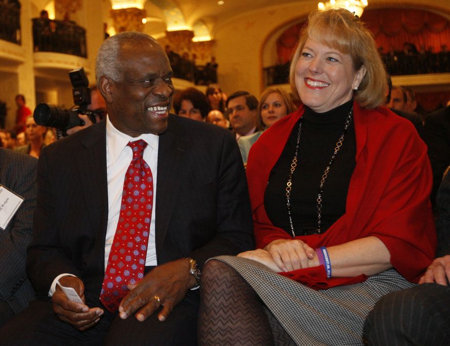 In this Nov. 15, 2007, photo, Supreme Court Justice Clarence Thomas, left, sits with his wife Virginia Thomas, as he is introduced at the Federalist Society in Washington, where he spoke about his new book and took questions from the audience. Virginia Thomas is asking Anita Hill to apologize for accusing the justice of sexually harassing her, 19 years after Justice Thomas' confirmation hearing spawned a national debate about harassment in the workplace. (AP Photo/Charles Dharapak)