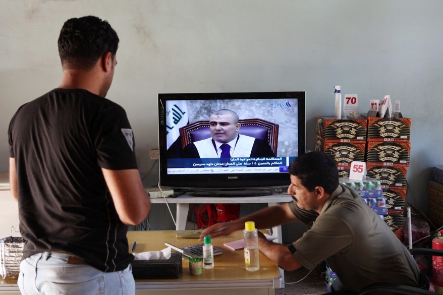 Iraqis in a Baghdad cafe watch the sentencing of Tariq Aziz. Saddam Hussein's right-hand man was convicted of "deliberate murder and crimes against humanity." (Associated Press)