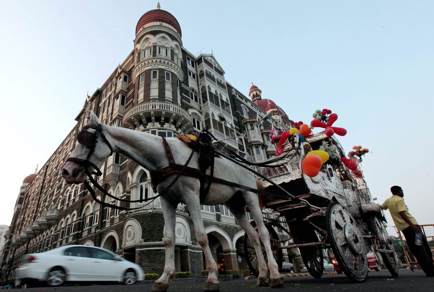 A horse-drawn carriage awaits a rider in front of the Taj Mahal hotel in Mumbai on Thursday. President Obama is scheduled to stay at this hotel, which was the scene of one of the so-called "26/11" attacks. (Associated Press)