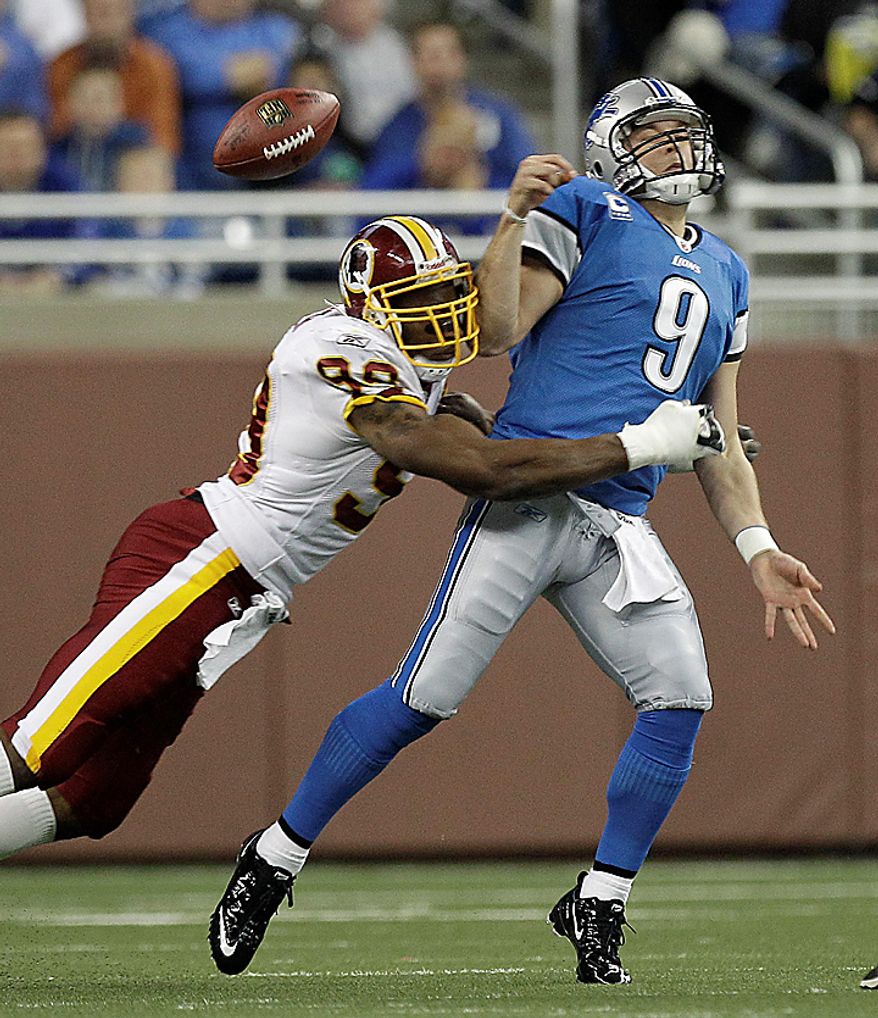 Washington Redskins linebacker Andre Carter (99) hits Detroit Lions quarterback Matthew Stafford (9), jarring the ball loose, during the first quarter of their NFL football game in Detroit, Sunday, Oct. 31, 2010. (AP Photo/Paul Sancya)