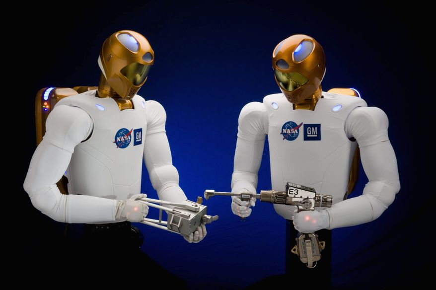 Robonaut 2 robots are seen in July 2009 in Houston. The Robonaut 2 taking off Wednesday for the International Space Station will stay there until the station stops operating after 2020. (NASA photograph via Associated Press)