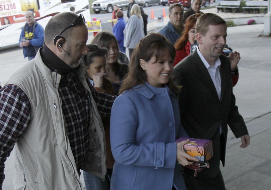 Delaware Republican U.S. Senate candidate Christine O'Donnell enters a polling place to cast her vote, Tuesday, Nov. 2, 2010, in Wilmington, Del. Miss O'Donnell is facing Democrat Chris Coons. (AP Photo/Rob Carr)