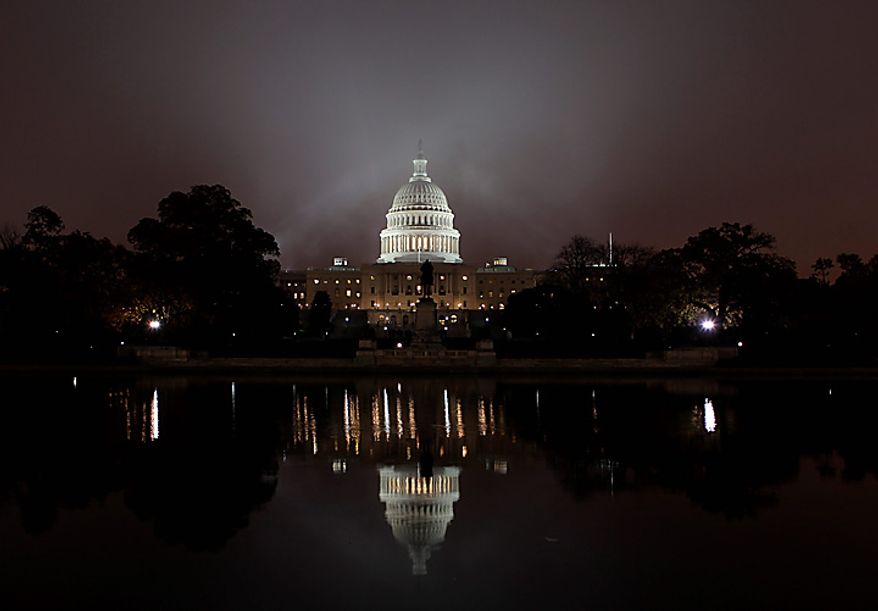 Fog envelopes Capitol Hill in Washington, at dawn Monday, Nov. 15, 2010, as Congress begins its lame duck session following a long break for the midterm elections. (AP Photo/J. Scott Applewhite)