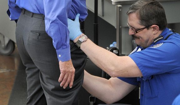 **FILE** In this photo from Nov. 17, a Transportation Security Administration agent performs an enhanced pat-down on a traveler at a security area at Denver International Airport in Denver. The TSA has demonstrated a knack for ignoring the basics of customer relations, while struggling with what experts say is an all but impossible task. (Associated Press/The Denver Post)