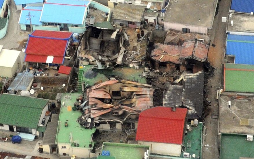 An aerial view shows destroyed houses on Yeonpyeong island, South Korea, Wednesday, Nov. 24, 2010, one day after North Korea's artillery attack on the island. Rescuers found the burned bodies Wednesday of two islanders killed in the attack _ the first civilian deaths from a skirmish that marked a dramatic escalation of tensions between the rival Koreas. (AP Photo/Yonhap, Kim Hyun-tae)
