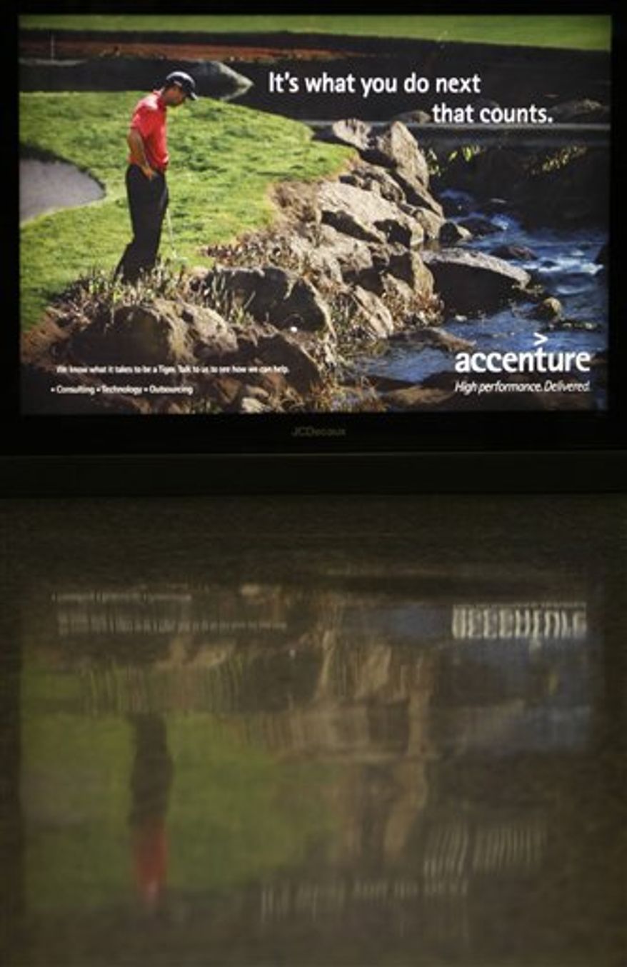 FILE - This Dec. 14, 2009, file photo shows an Accenture ad featuring Tiger Woods at Dulles International Airport in Chantilly, Va. When Woods ran his SUV over a fire hydrant last Nov. 27, unleashing a torrent of tawdry and shocking details about his infidelities, those clever catch phrases quickly became punchlines. A year has passed since the infamous crash that started it all, and Woods appears ready to re-enter the marketing game. (AP Photo/Luis M. Alvarez, File)