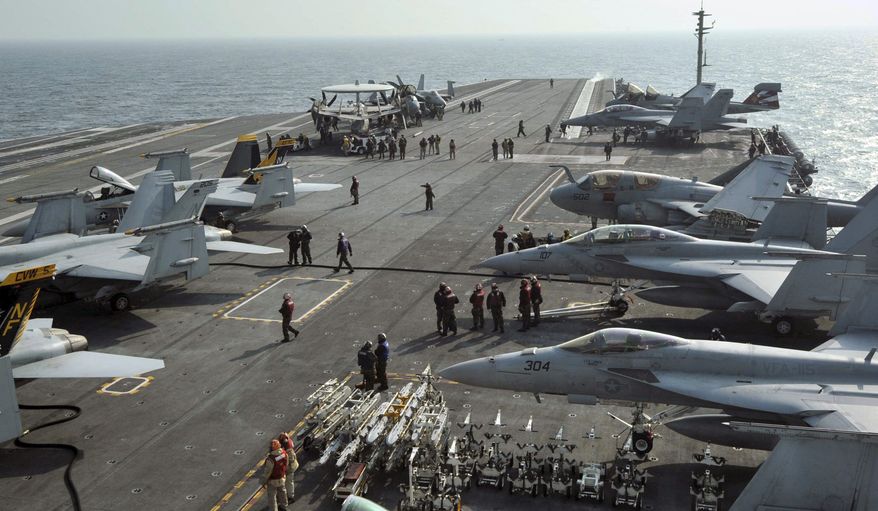 U.S. Navy Carrier Air Wing Five aircraft are tied down on the flight deck of the USS George Washington during joint military drills with South Korean forces off that country's west coast on Monday, Nov. 29, 2010. (AP Photo/Korea Pool)