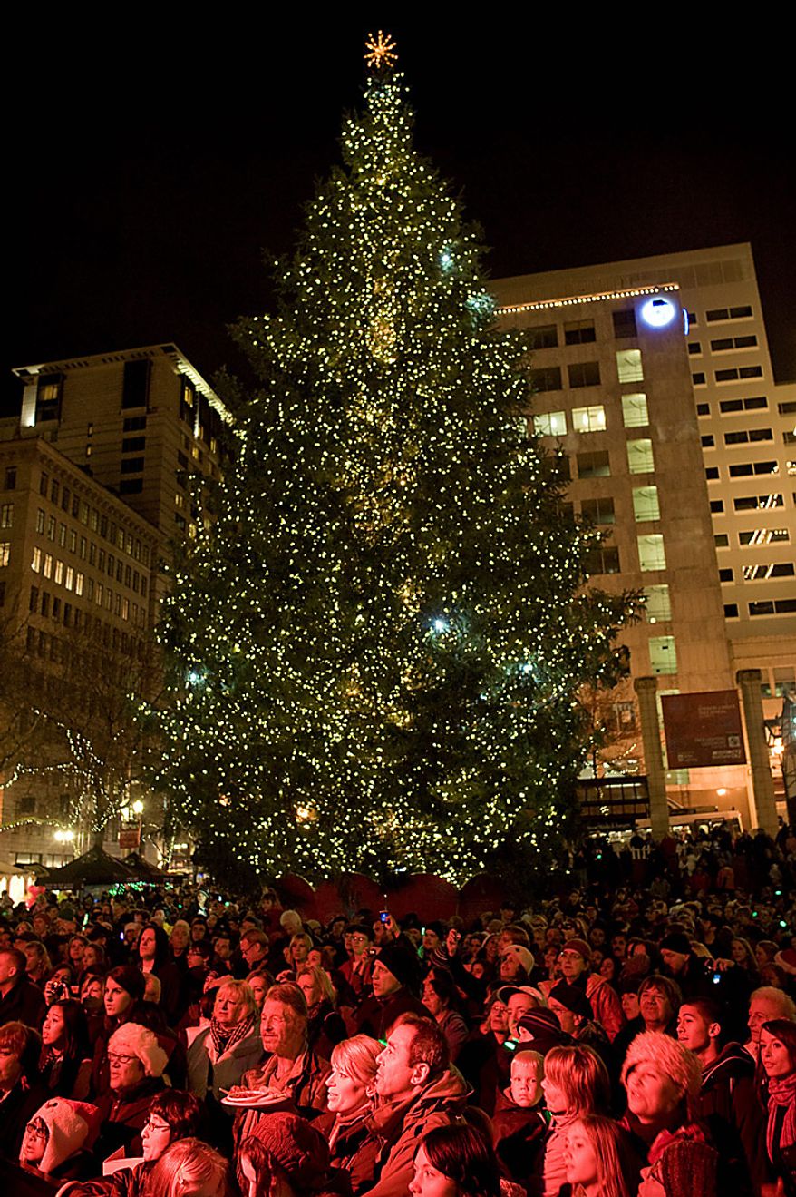 The tree is lit on Pioneer Courthouse square Friday night Nov. 26, 2010 to the music of Pink Martini and with Santa Claus in front of a shoulder-to-shoulder crowd singing holiday music in the square. A Somali-born teenager, Mohamed Osman Mohamud, 19, was arrested at 5:40 p.m. just after he dialed a cell phone that he thought would blow up a van laden with explosives but instead brought federal agents and Portland police swooping in to take him into custody, federal prosecutors said. He was charged with attempted use of a weapon of mass destruction. (AP Photo/Torsten Kjellstrand - The Oregonian)