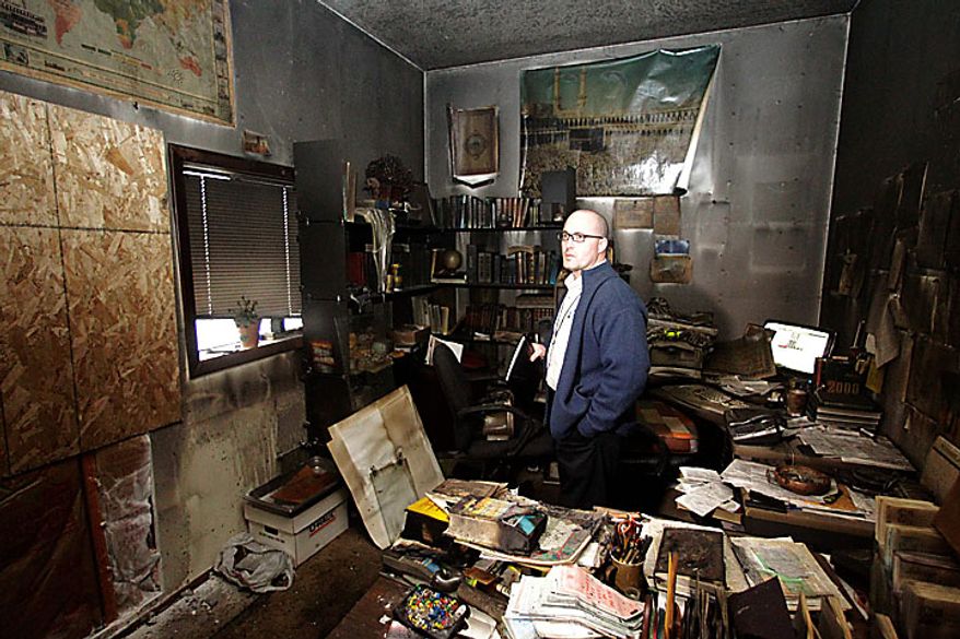 Cpt. Jonathan Sassman, of the Corvallis Police Department looks over fire damage at the Salman Al-Farisi Islamic Center in Corvallis, Ore., Sunday, Nov. 28, 2010, where an alleged arsonist set a fire in the early morning hours. Anger on Sunday over a Somali-born teen's failed plan to blow up a van full of explosives during Portland's Christmas tree lighting ceremony apparently erupted in arson on Sunday when a fire damaged the Islamic center once frequented by the suspect. (AP Photo/Rick Bowmer)