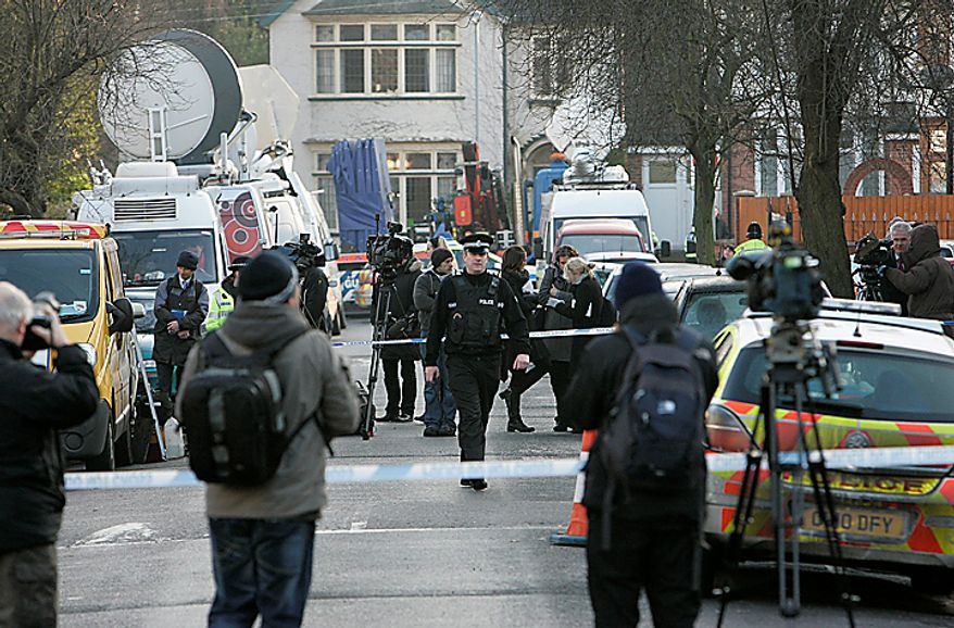 The media gather as a police officer walks outside the house which was searched by British police in Luton, England, Monday, Dec. 13, 2010. A Swedish prosecutor says police are "98 percent" certain the Stockholm suicide bomber is 28-year-old Taimour Abdulwahab who is a Swedish citizen but also lived several years in Britain. Prosecutor Tomas Lindstrand Monday said Abdulwahab has his roots in the Middle East and has been a Swedish citizen since 1992. Lindstrand said Abdulwahab was also the registered owner of the car that exploded in Stockholm shortly before the suicide blast Saturday. (AP Photo/Akira Suemori)