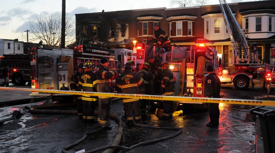 Six people are dead after an early-morning two-alarm fire in the 2300 block of Homewood Avenue in Baltimore on Tuesday, Dec. 14, 2010. (AP Photo/Baltimore Sun, Kim Hairston)