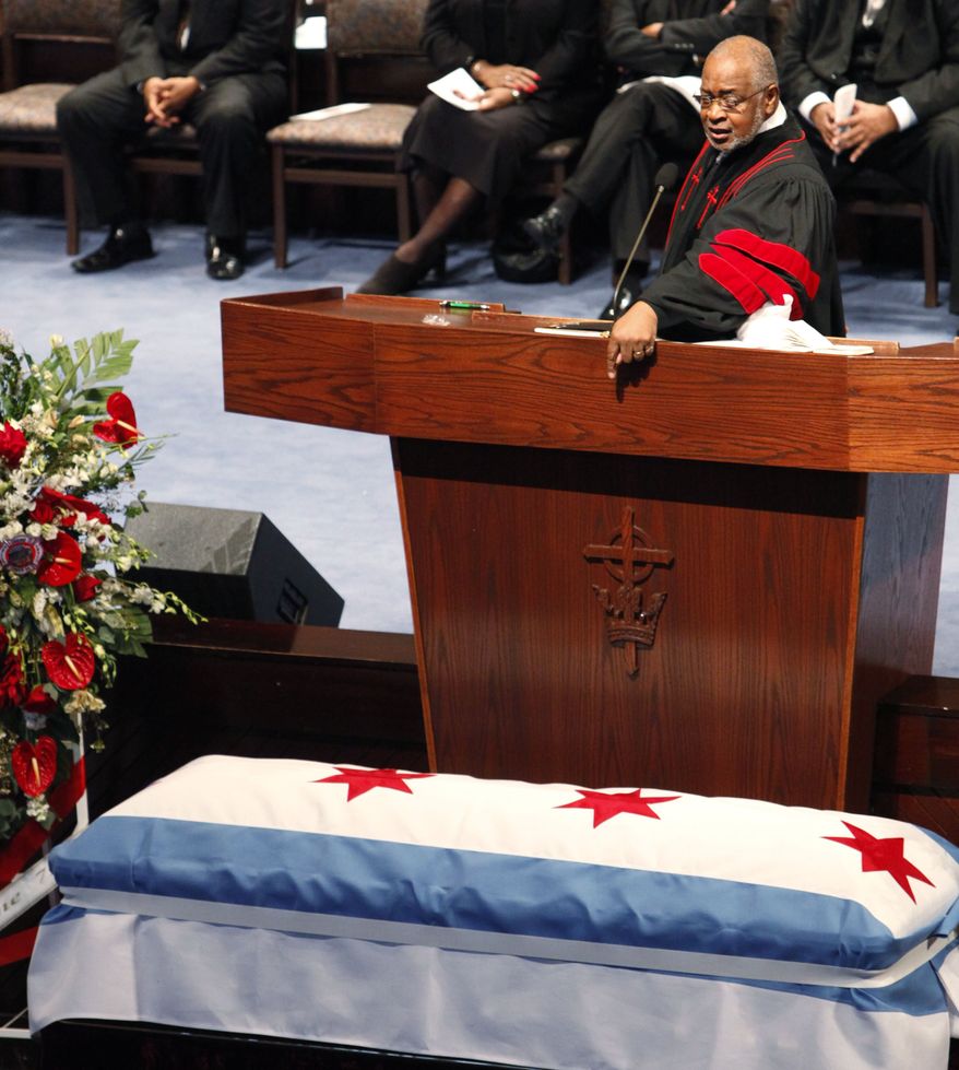Rev. Dr. Louis D. Jones eulogizes Chicago firefighter Corey Ankum during Dec. 30 funeral services in Chicago. Ankum was one of two firefighters killed last week when a roof collapsed after a fire. (Associated Press)