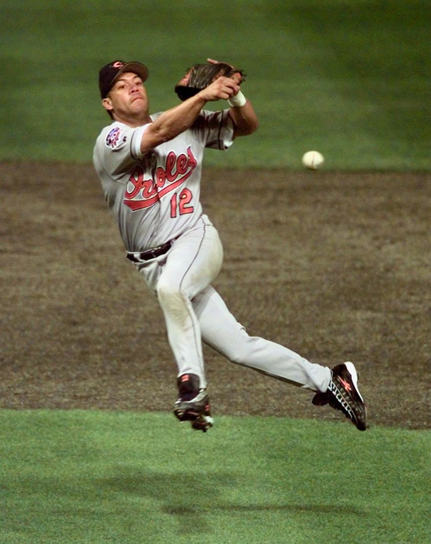 FILE - In this Oct. 12, 1997, file photo, Baltimore Orioles' Roberto Alomar throws out Cleveland Indians' Bip Roberts to end the fourth inning of Game 4 of the American League Championship Series at Jacobs Field in Cleveland, Ohio. Alomar and Bert Blyleven hope they're on deck for the Hall of Fame when the results from the Baseball Writers' Association of America election are released Wednesday, Jan. 5, 2011. (AP Photo/Jim Mone, File)