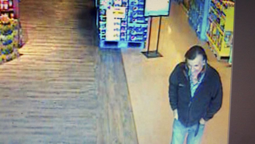 A security camera image from video shows a person whom the Pima County Sheriff's Department is trying to identify after being seen at the location of the shooting of Rep. Gabrielle Giffords in Tucson, Ariz., on Saturday, Jan. 8, 2011, possibly in association with the shooting suspect. He is described as a Caucasian male, approximately 40 to 50 years old with dark hair, and was last seen wearing blue jeans and a dark blue jacket. (AP Photo/Pima County Sheriff's Department)
