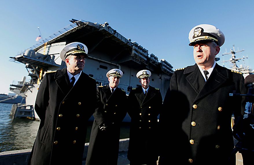 Commander of the USS Enterprise, Capt. Dee L. Mewbourne, right, speaks to the press as the nuclear powered aircraft carrier prepares to deploy to support forces in Afghanistan at Naval Station Norfolk in Norfolk, Va., Thursday, Jan. 13, 2011. The USS Enterprise is deploying without its former commander, Capt. Owen Honors, as Navy brass investigates bawdy, sexually themed videos he showed to thousands of crew members. (AP Photo/Steve Helber)