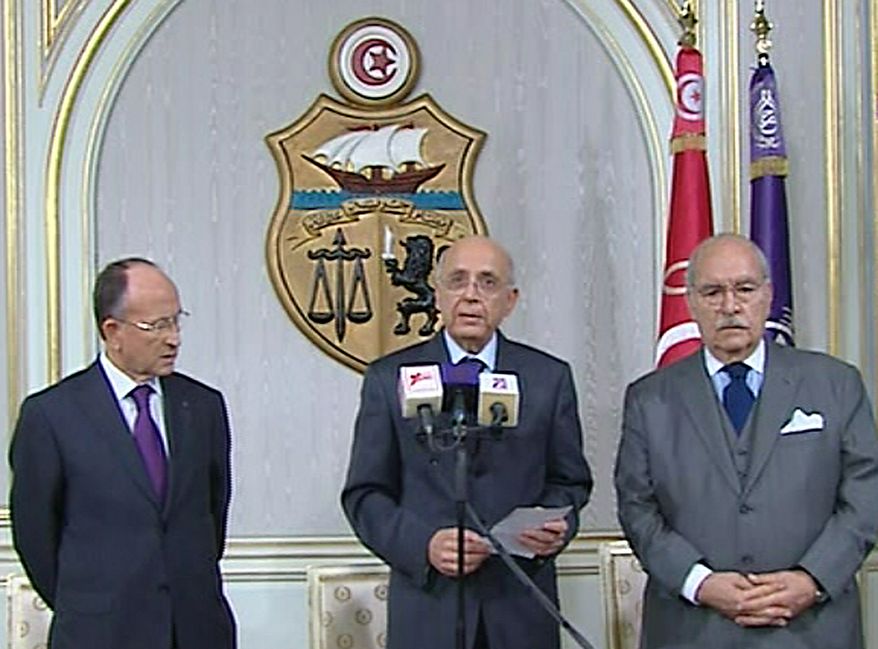 Prime Minister of Tunisia, Mohammed Ghannouchi, centre, appears on state television with other unidentified government members, Friday Jan. 14, 2011, to announce that he is assuming power in Tunisia. The announcement came on Friday after many thousands of protesters mobbed the capital of Tunis to demand the ousting of President Zine El Abidine Ben Ali, and unconfirmed reports said he has left the country. Prime Minister Ghannouchi announced on TV that he will hold power until early elections are held. (AP Photo) TV OUT - NO SALES