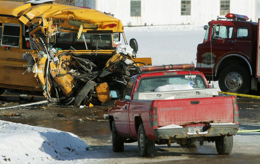 The front end of a school bus sits with its front end crushed after it struck the back of a town snow plow in Savannah, N.Y., on Thursday. Twenty-two children and the driver were injured, authorities said. (Associated Press)