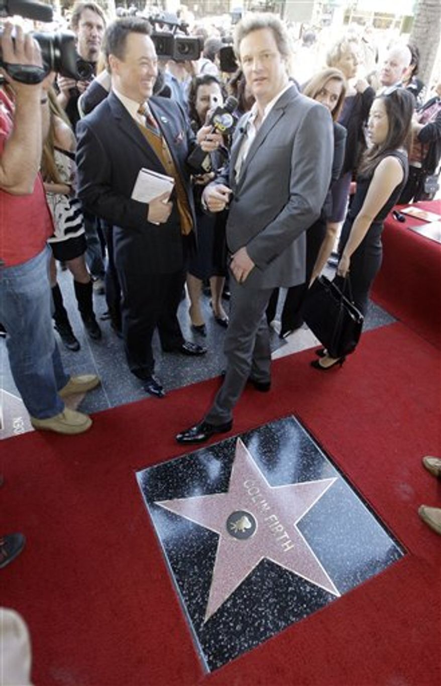 FILE - In this Jan. 13, 2011 file photo, British actor Colin Firth, star of "The King's Speech," points back to the Pig 'N' Whistle Pub as he is interviewed during dedication ceremonies for his new star on the Hollywood Walk of Fame in Los Angeles. Every year around now, tens of thousands of DVDs of movies still shown in theaters are sent by movie studios to Oscar, Golden Globe and other awards voters. Every year, some of these discs are copied, and the movies end up being shared online, where they can cut into movie-ticket and DVD sales.(AP Photo/Reed Saxon, file)