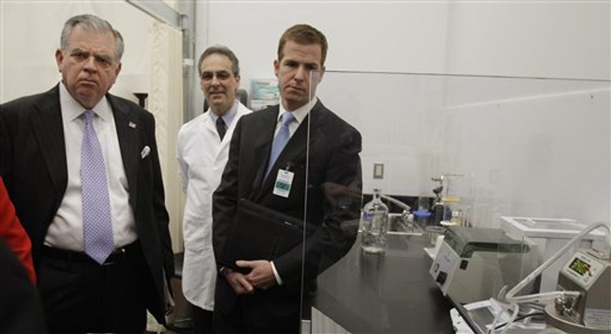 U.S. Transportation Secretary Ray LaHood is shown the new Driver Alcohol Detection System for Safety (DADSS), one of the prototype components, a small black box attached to wires, seen at far right, during a news conference announcing the device in Waltham, Mass., Friday morning, Jan. 28, 2011. Shane Karr, vice-president for Federal Government Affairs at the Alliance of Automotive Manufacturers looks on at right, as Laura Dean Mooney, national president of Mothers Against Drunk Driving (MADD) watches at left. (AP Photo/Stephan Savoia)