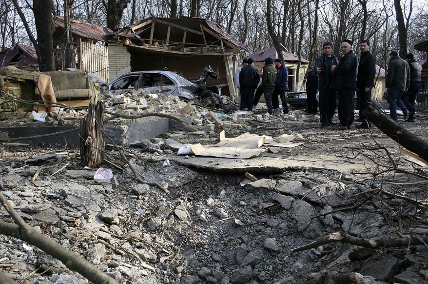 ** FILE ** Investigators work at the site of an explosion near a cafe in the town of Khasavyurt, Dagestan, southern Russia, on Saturday, Jan. 15, 2011. An explosive-laden car exploded near the White Nights cafe in the town of Khasavyurt in Dagestan, killing and wounding several persons. The town borders Chechnya, where two conflicts with the federal government in Moscow fueled the rise of Islamic militancy in the Northern Caucasus region. (AP Photo/Ruslan Alibekov, NewsTeam)