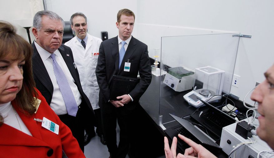Transportation Secretary Ray LaHood (center) examines the new Driver Alcohol Detection System for Safety in Waltham, Mass., on Friday. One of the prototype components is a small black box attached to wires (far right). Shane Karr (right), vice president for Federal Government Affairs at the Alliance of Automotive Manufacturers, looks on. Laura Dean Mooney (left), national president of Mothers Against Drunk Driving, watches. (Associated Press)