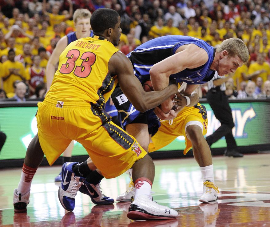 Maryland forward Dino Gregory (33) battles for the ball against Duke forward Mason Plumlee, center, during the first half of an NCAA college basketball game Wednesday, Feb. 2, 2011, in College Park, Md. (AP Photo/Nick Wass)
