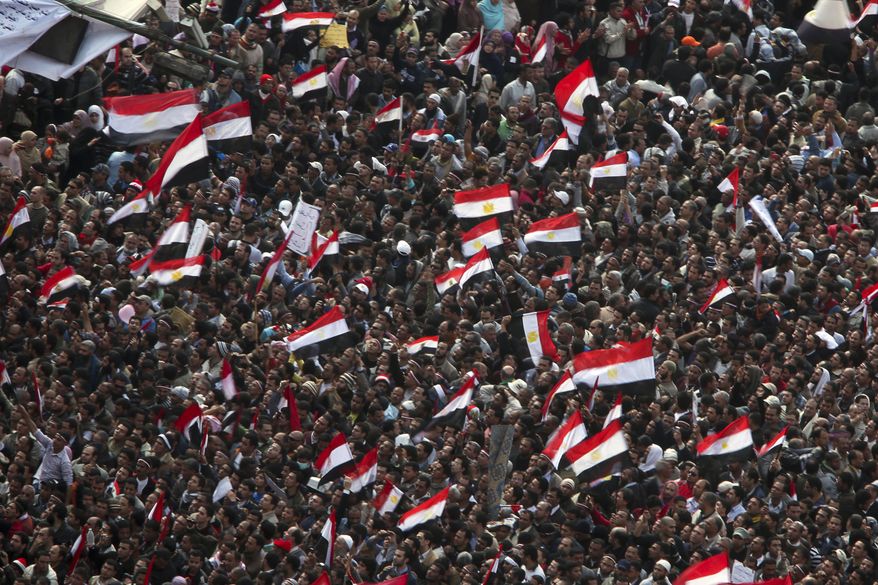 Anti-government protesters demonstrate after traditional Muslim Friday prayers at the continuing demonstration in Tahrir Square in downtown Cairo Friday, Feb. 11, 2011. (AP Photo/Tara Todras-Whitehill)