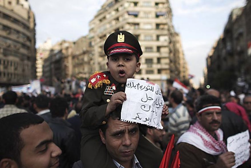 An Egyptian boy dressed as an army colonel sits on his father's shoulders in Tahrir Square in Cairo Thursday, Feb. 10, 2011. (AP Photo/Tara Todras-Whitehill)