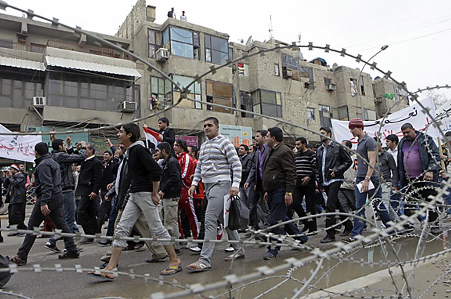 Protesters chant anti-government slogans during a demonstration in Baghdad, Iraq, Friday, Feb. 11, 2011. In at least four morning demonstrations across Baghdad, protesters painted a picture of their homeland that they said has fewer services and more corruption than in Egypt. The rally moved into Baghdad's own "Tahrir Square" in the capital's center, where they joined about 300 people chanting against government corruption and Iranian influence over its leaders. (AP Photo/Khalid Mohammed)
