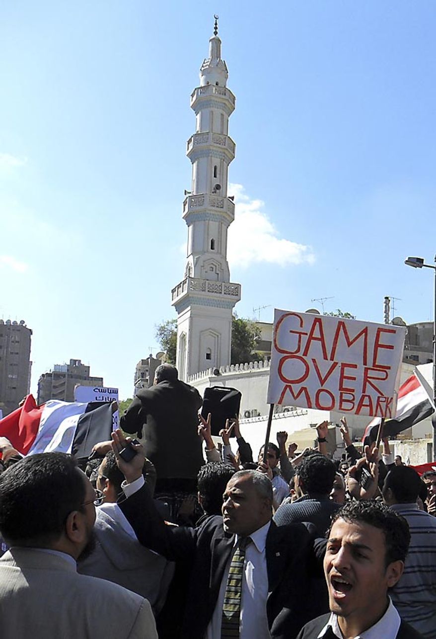 Egyptian anti-government protesters march in Assiut, Egypt, Friday, Feb. 11, 2011. Egyptian government announced later Friday that President Hosni Mubarak has stepped down. (AP Photo/Mamdouh Thabet)