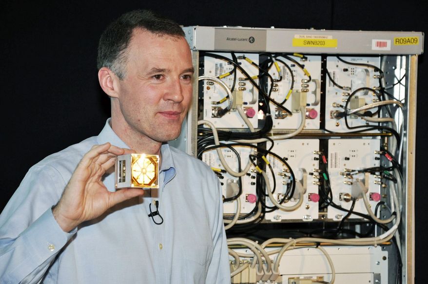 Associated Press photo
Wim Sweldens, the president Alcatel-Lucent's wireless division, holds a lightRadio cube, a small cell-phone antenna that can be deployed on lampposts and buildings.
