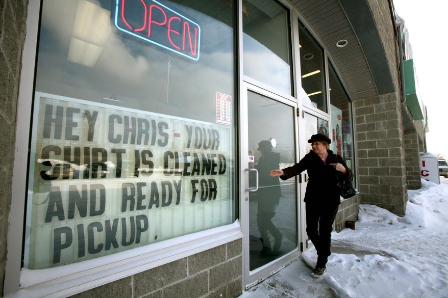ASSOCIATED PRESS
Karen Machovoe, of Lancaster, N.Y., enters a dry cleaners, where a sign pokes fun at the bare-chested-photo scandal of local Republican Rep. Christopher Lee that prompted his quick resignation.