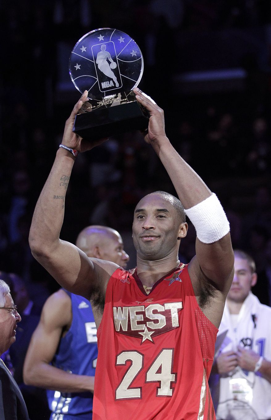 West's Kobe Bryant holds up the MVP trophy after the NBA's All-Star Game in Los Angeles on Sunday. The West won 148-143. (Associated Press)