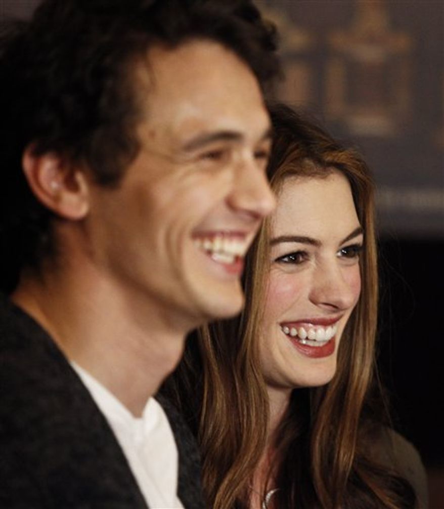 Actors James Franco, left, and Anne Hathaway talk to the media at the Kodak Theatre in the Hollywood section of Los Angeles, Thursday, Feb. 24, 2011. Franco and Hathaway are hosting 83rd Academy Awards, which airs Sunday. (AP Photo/Chris Carlson)