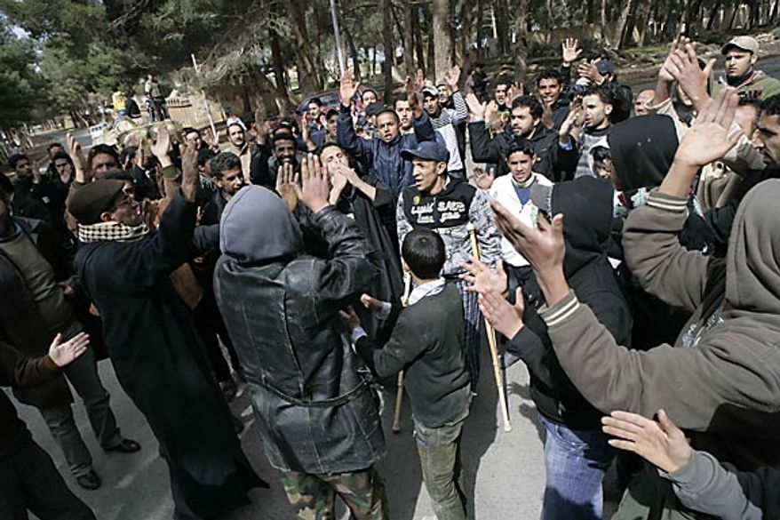 In this photo released by China's Xinhua News Agency, anti-government protesters celebrate in the east Libyan city of Albayda Thursday, Feb. 24, 2011. (AP Photo/Xinhua, Nasser Nouri)