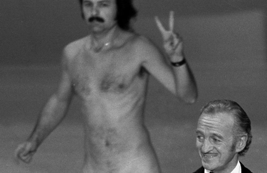Actor David Niven presents an award as streaker Robert Ope crosses the stage during the 1974 Academy Awards show in Los Angeles. (Photo: Associated Press)