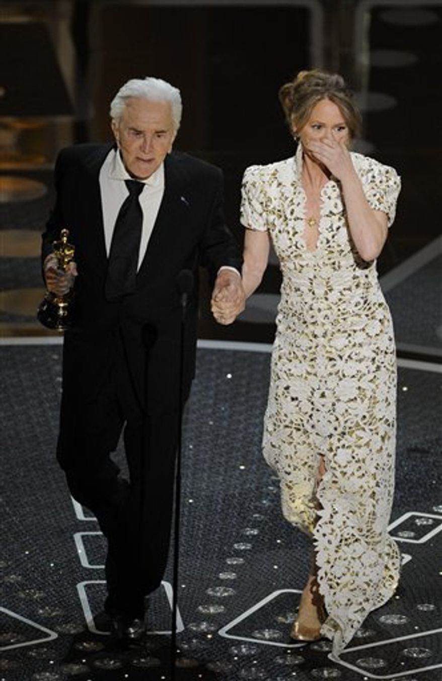 Kirk Douglas escorts Melissa Leo after she accepted the Oscar for best actress in a supporting role for "The Fighter" at the 83rd Academy Awards on Sunday, Feb. 27, 2011, in the Hollywood section of Los Angeles. (AP Photo/Mark J. Terrill)