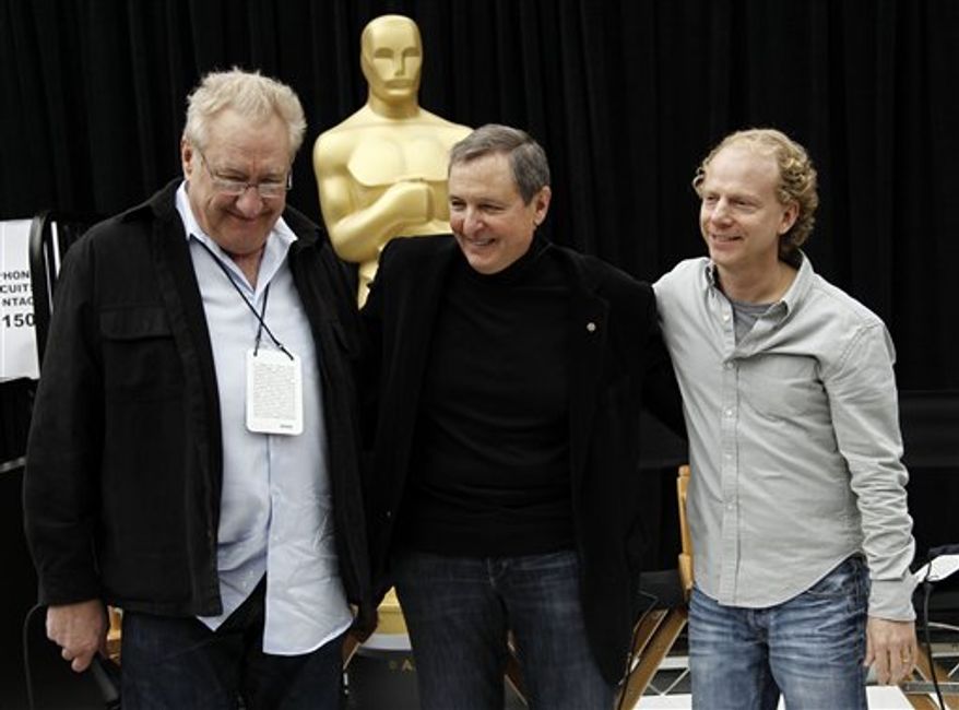 Oscar statues stand in front of the Kodak Theatre as preparations for the 83rd Academy Awards continue in Los Angeles, Saturday, Feb. 26, 2011. (AP Photo/Jae C. Hong)