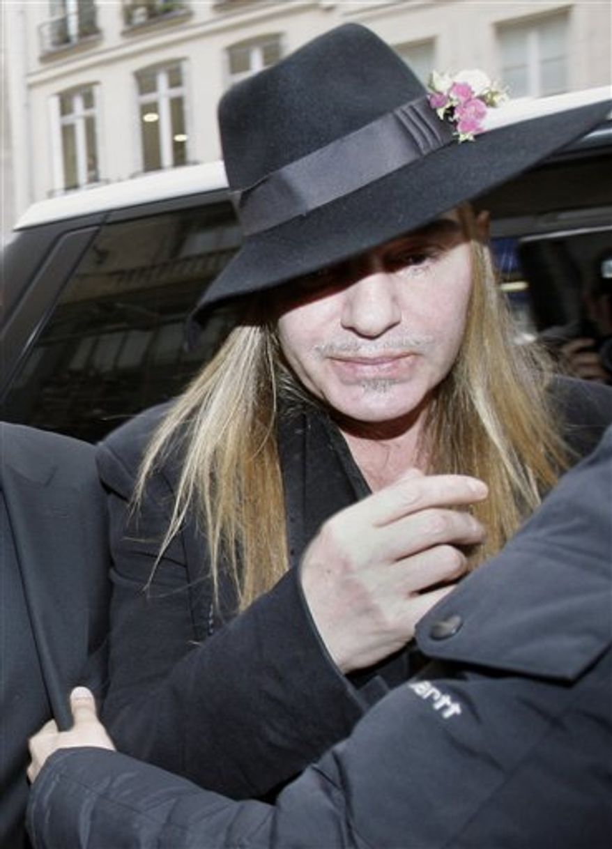 Fashion designer John Galliano arrives at a police station in Paris, Monday, Feb. 28, 2011. Galliano arrived Monday at a Paris police station to face accusations that he made illegal anti-Semitic slurs, hours after a video emerged of the famed fashion designer praising Adolf Hitler. The Gibraltar-born designer, wearing a wide-brimmed black hat, made no comment to reporters as he entered to face claims by a couple that he made an anti-Semitic remark during a dispute at a trendy Paris cafe. (AP Photo/Michel Euler)