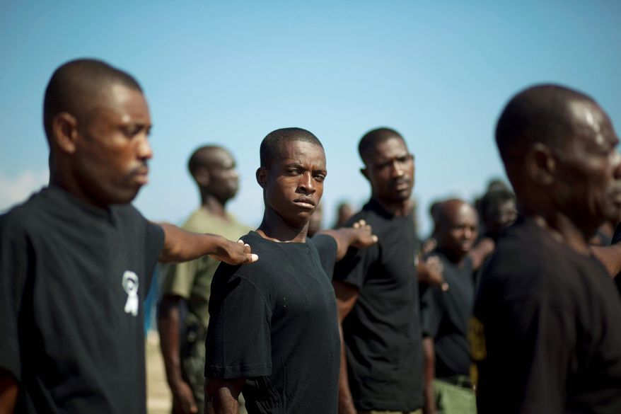 Nestor Apolon, the self-appointed commander of the civililan volunteers, says "thousands and thousands" are waiting to be trained. There are no weapons visible at the makeshift base in Carrefour. (Associated Press)