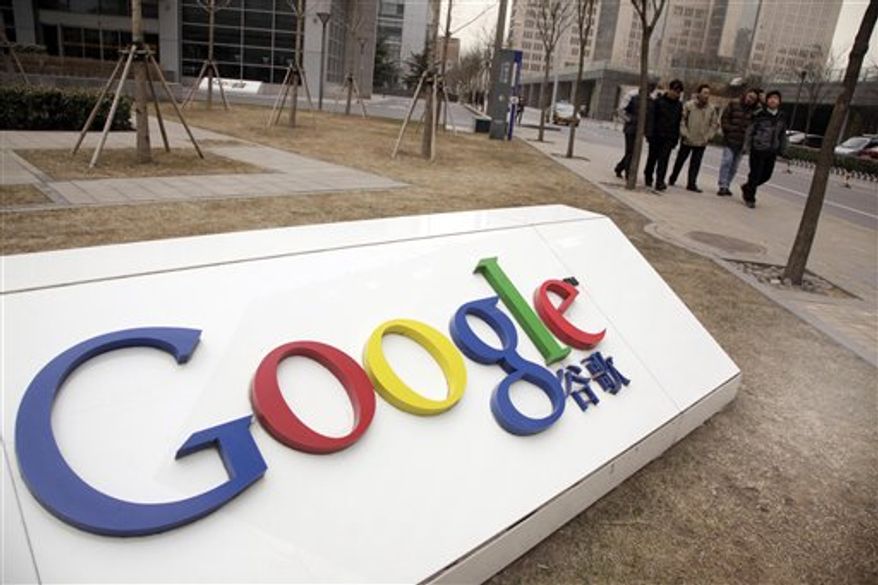 ** FILE ** Pedestrians pass the Google China headquarters in Beijing in March 2010. (AP Photo/Ng Han Guan, File)