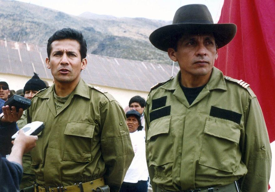 Ollanta Humala (left), a former Peruvian army officer and current presidential candidate, talks with reporters next to his brother, Antauro Humala, during their short-lived military rebellion in October 2000. (Associated Press)