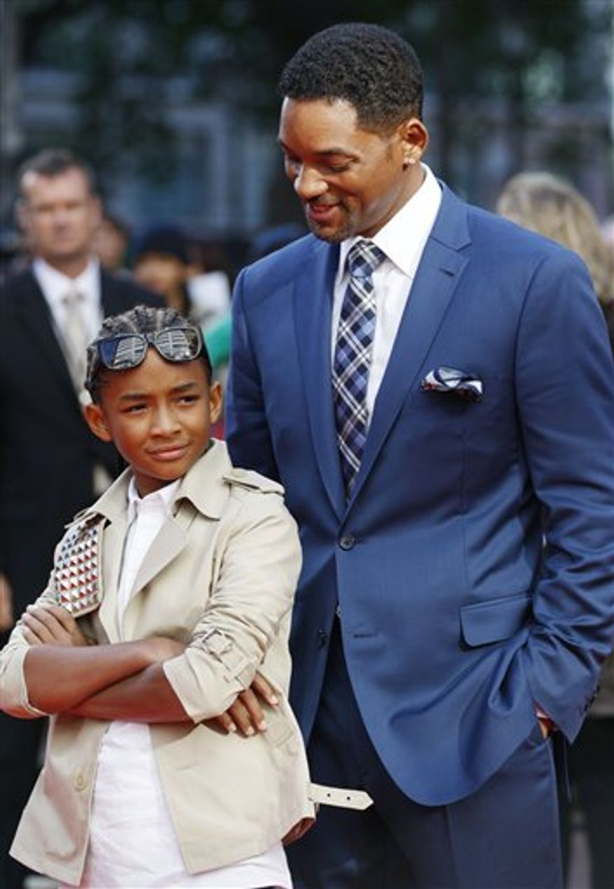 FILE - In this July 15, 2010 file photo, actors Jaden Smith, left, and his father Will Smith arrive for the gala premiere of the film Karate Kid in London. (AP Photo/Sang Tan, file)