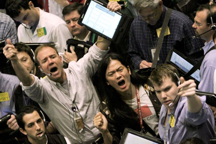 Traders work the crude oil options pit at the New York Mercantile Exchange on Tuesday. Oil is falling after Goldman Sachs warned investors that crude is due for a "substantial pullback." Oil imports fell in February. (Associated Press)