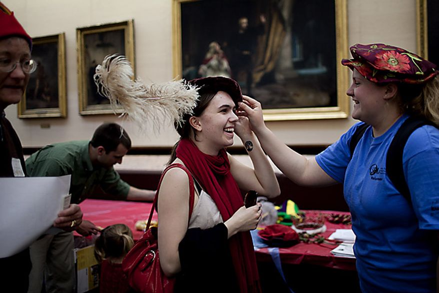 Rachel Carleton (left) tries on a Renaissance era hat as her friend Lyndsie Collis looks on during an open house for Shakespeare's Birthday at the Folger Shakespeare Library, in Washington, D.C., Sunday, April 17, 2011. The girls attend Cornell University and were in town for an environmental conference and decided to stop by the open house in the spare time. (Drew Angerer/The Washington Times)