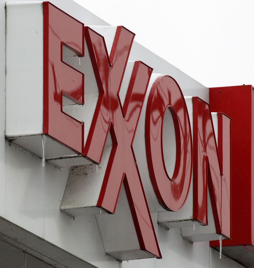 **FILE** An Exxon sign is displayed Jan. 27 atop a minimarket in Carnegie, Pa. (Associated Press)