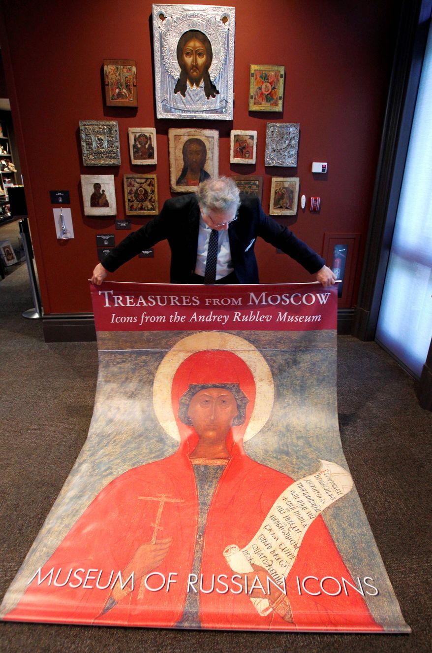 ASSOCIATED PRESS PHOTOGRAPHS
Kent Russell, curator at the Museum of Russian Icons in Clinton, Mass., displays a poster for a canceled exhibition of Russian icons. The objects, lent by the Andrey Rublev Museum in Moscow, were sent back to Russia.