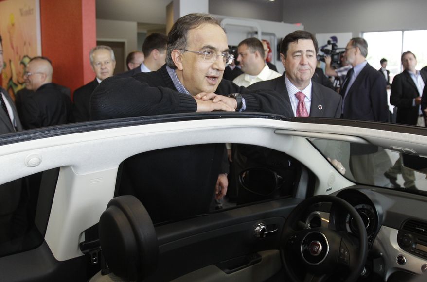 Chrysler CEO Sergio Marchionne leans on a Fiat 500 cabriolet at the opening of the Fiat of Lakeside dealership in Macomb Township, Mich., on Monday, May 23, 2011. (AP Photo/Carlos Osorio)