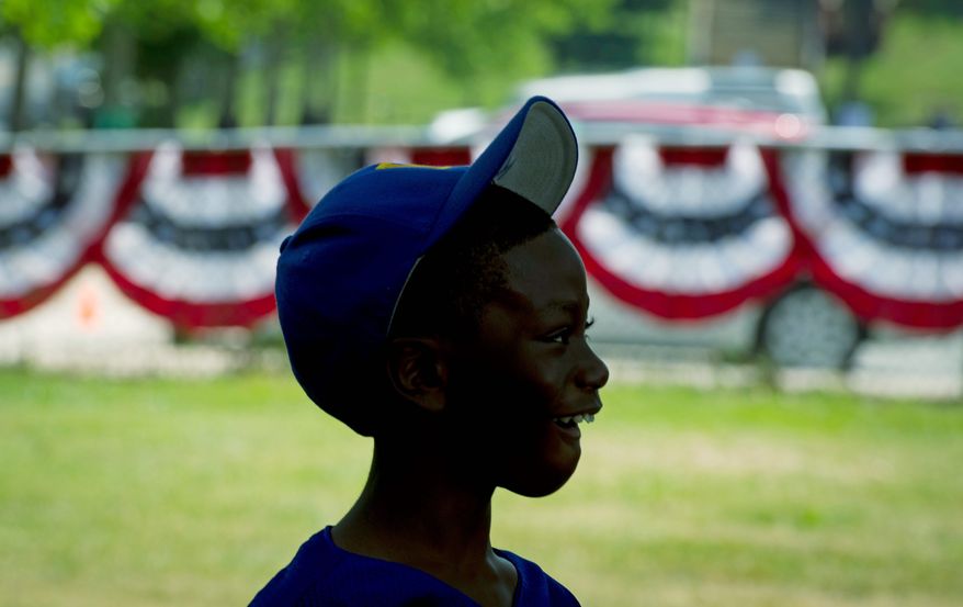 Kwon Holes, 11, watches the speakers Tuesday during the Washington Nationals Youth Baseball Academy groundbreaking ceremony at Fort DuPont Park in Southeast. (Rod Lamkey Jr./The Washington Times)